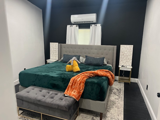 Bedroom 1 with teal headboard at The Cozy Cottage at The W