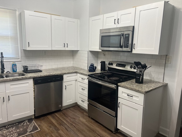 Full kitchen with stove and counters at The Cozy Cottage at The W