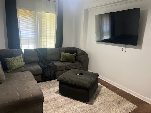 Living room with sectional couch at The Cozy Cottage at The W